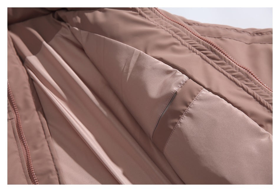 Close-up of the dusty mauve jacket's open interior, showing the lining and inner seam beside the zipper.