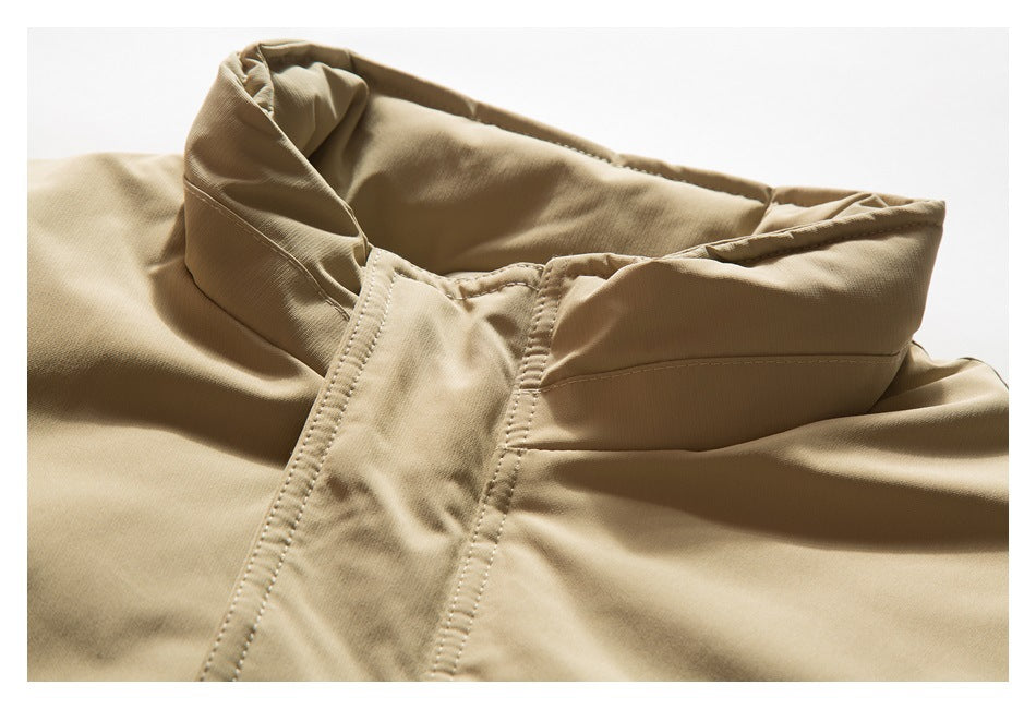 Close-up of the tan jacket's stand collar and stitched neckline.
