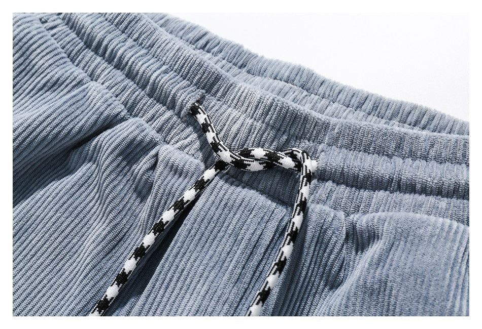 Close-up of the light blue pants' elastic waistband and black-and-white drawstring.