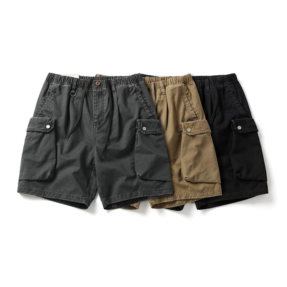 Three pairs of cargo shorts displayed together in charcoal gray, tan, and black.