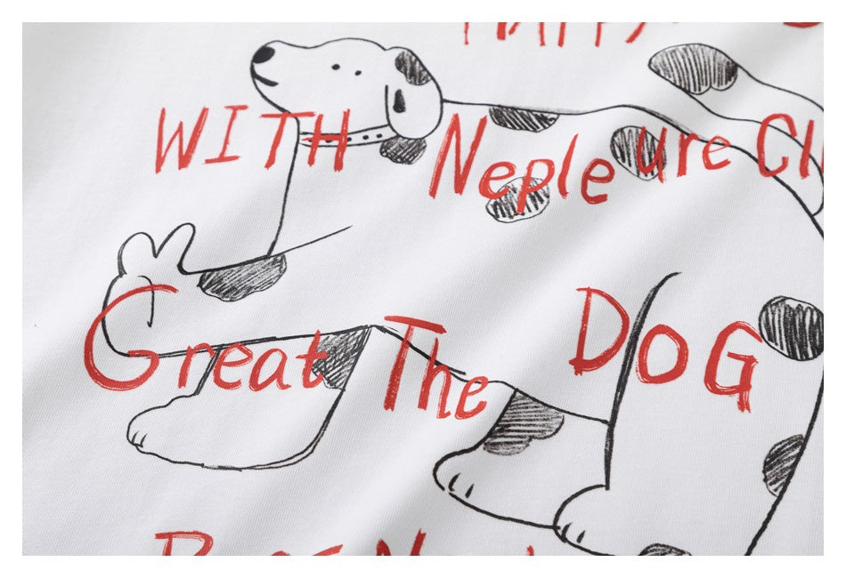 Close-up of the T-shirt's spotted dog illustration and red lettering printed on white fabric.