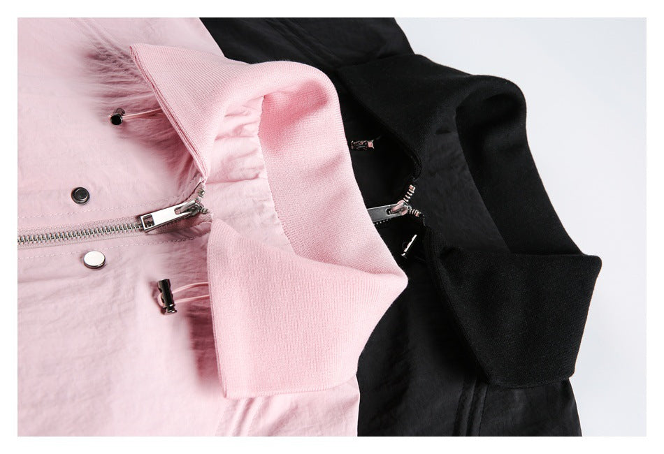 Close-up of pink and black jacket collars, front zippers, and metal drawcord toggles.