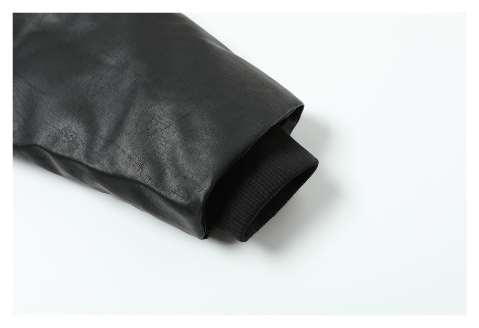 Close-up of a black jacket sleeve ending in a ribbed black cuff.