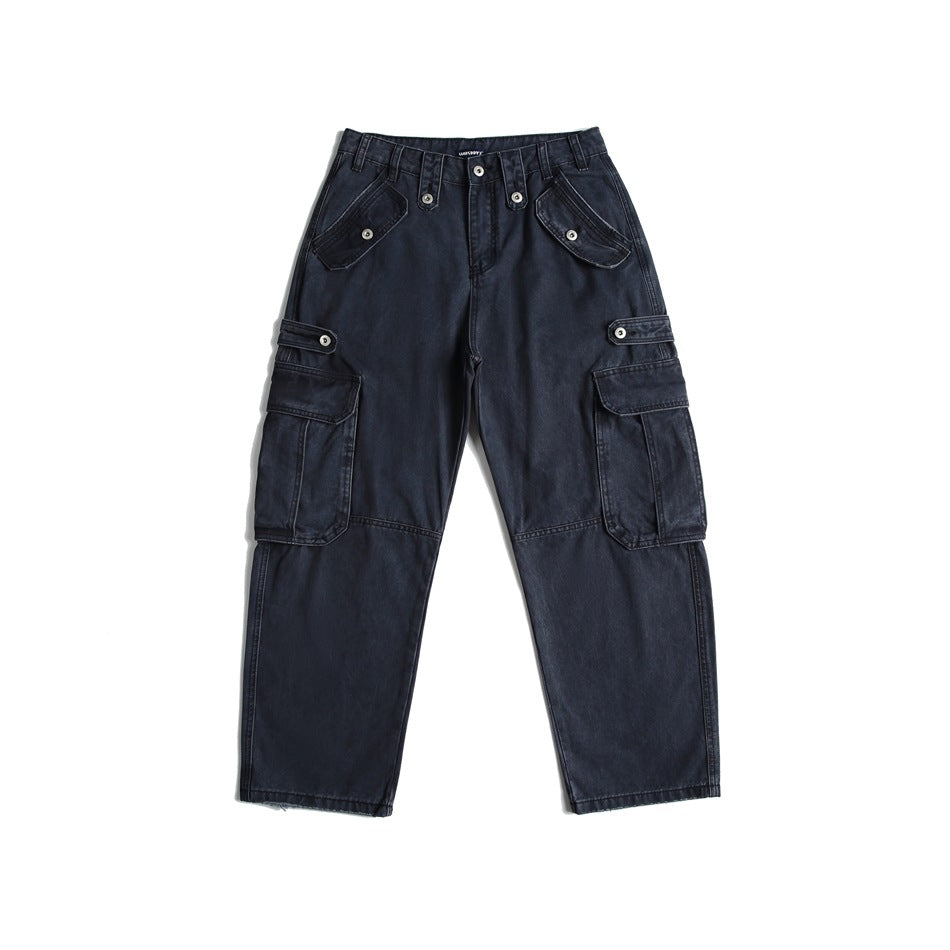 Washed dark blue-black cargo pants flat lay, front view, with multiple snap-button flap pockets