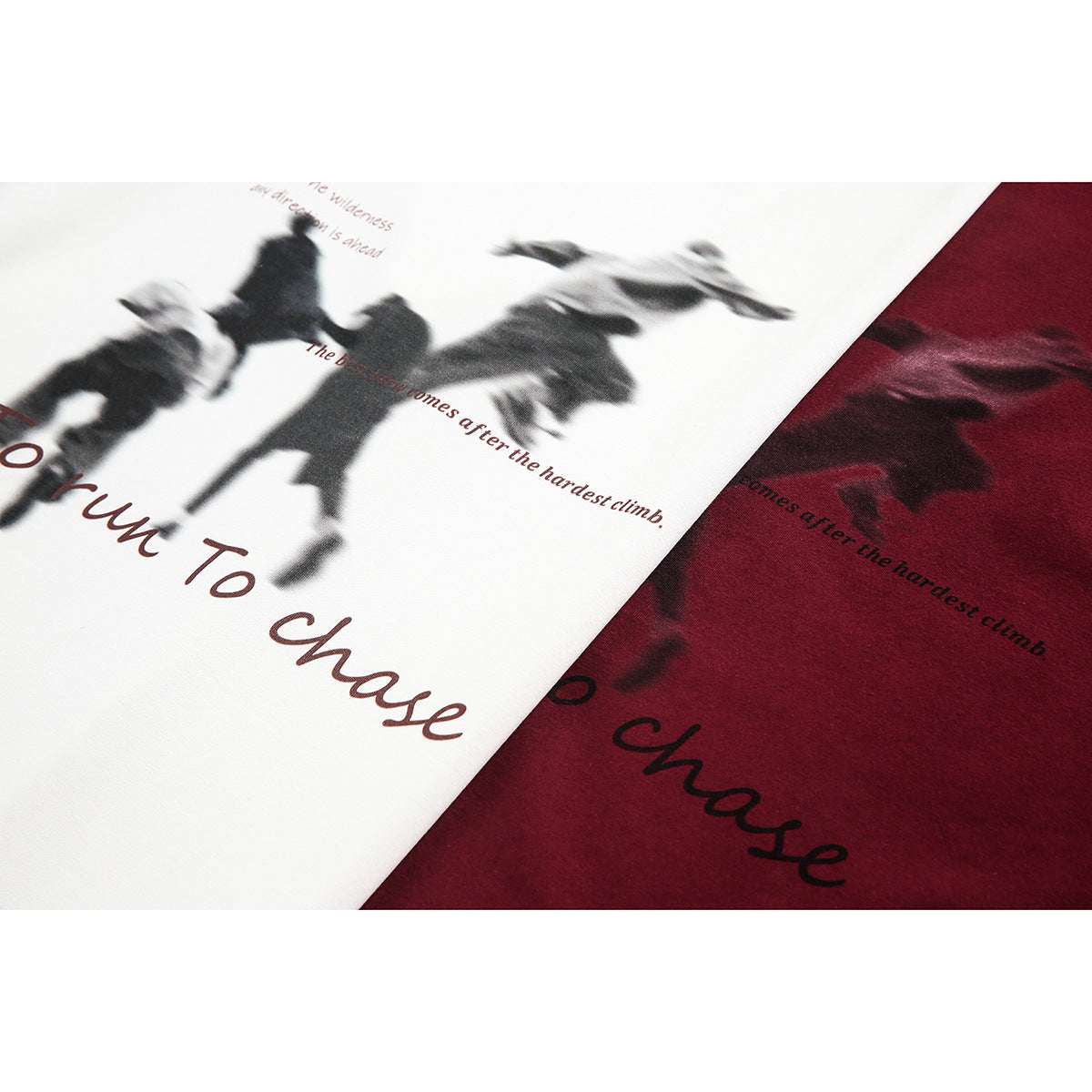 Close-up of cream and burgundy T-shirts showing blurred black graphic prints and English lettering.