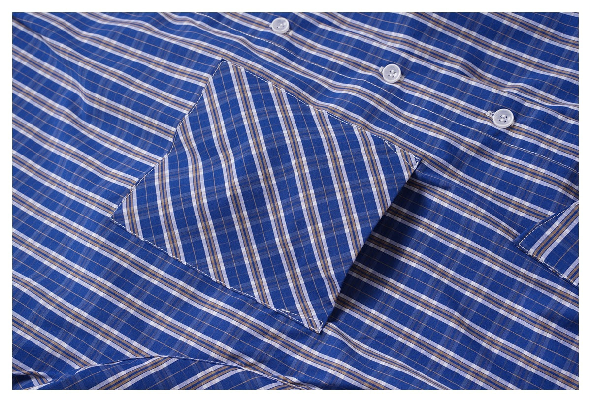 Close-up of the blue plaid shirt's chest pocket and button placket.