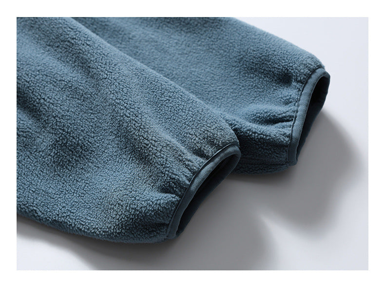 Close-up of two blue-gray fleece sleeve cuffs with dark edging.