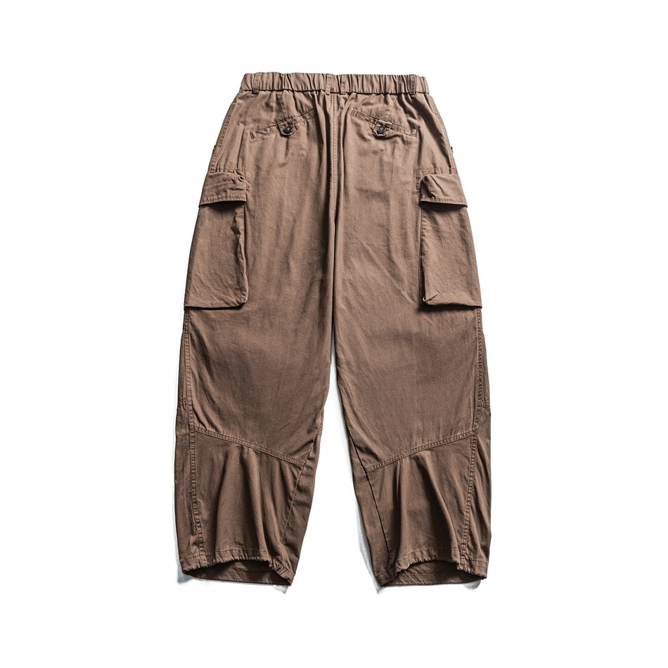 Back view of camel brown wide-leg cargo pants with button-flap back pockets and side cargo pockets