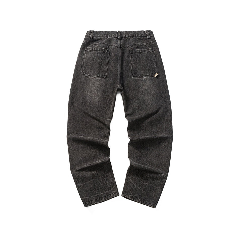 Flat-lay back view of black faded wash jeans showing two patch back pockets and a belt-loop waistband