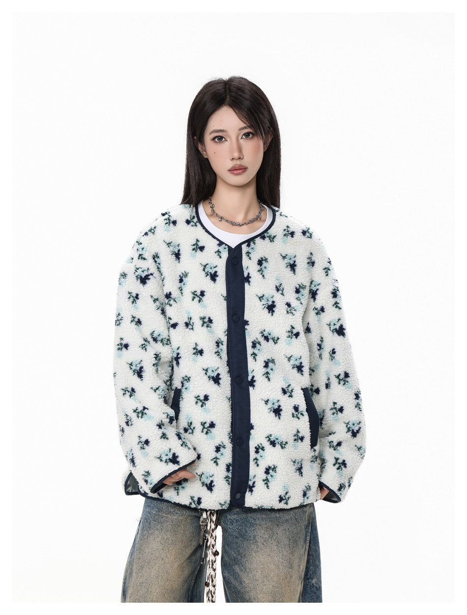 Model wearing white floral collarless fleece-textured jacket with navy snap placket over a white tee, close-up