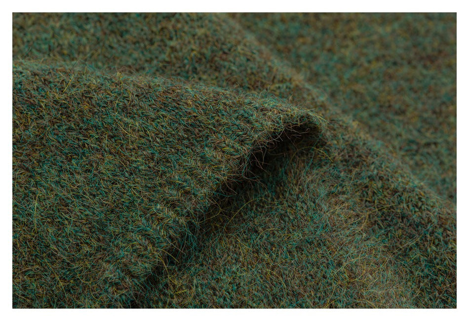 Close-up of a folded edge in mottled teal-brown fuzzy knit.