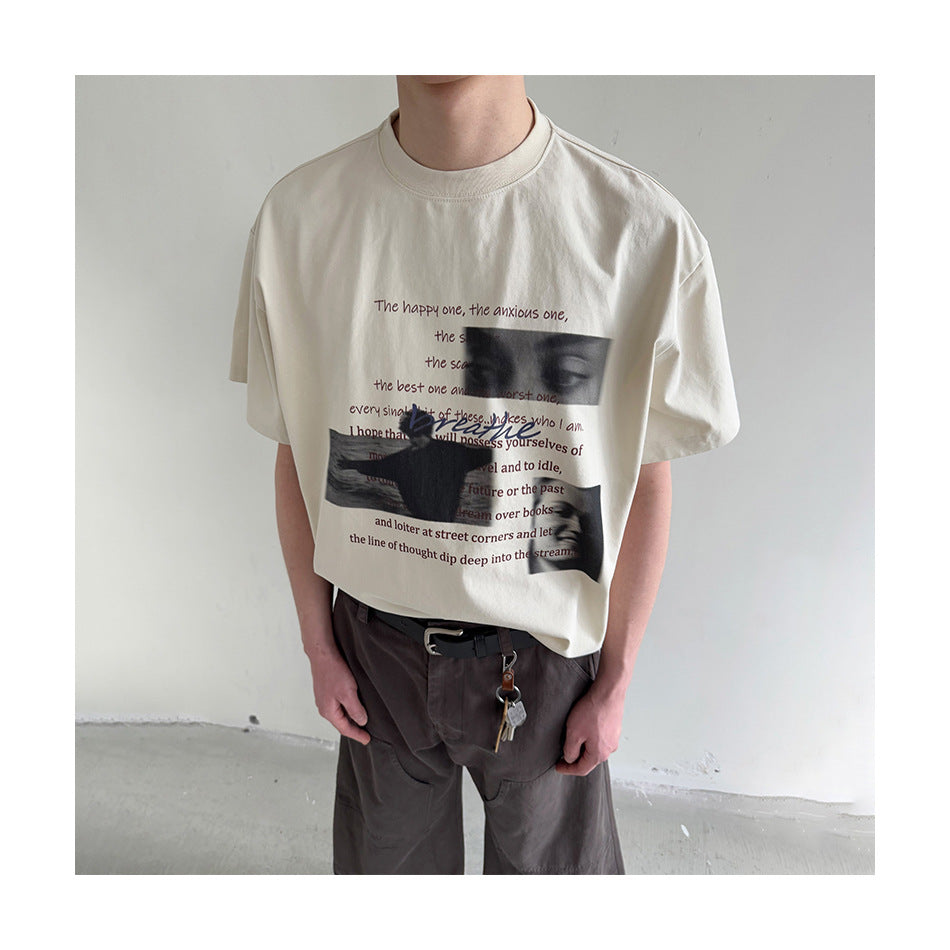 Person wearing a cream graphic T-shirt with English text and grayscale face images, paired with dark trousers.