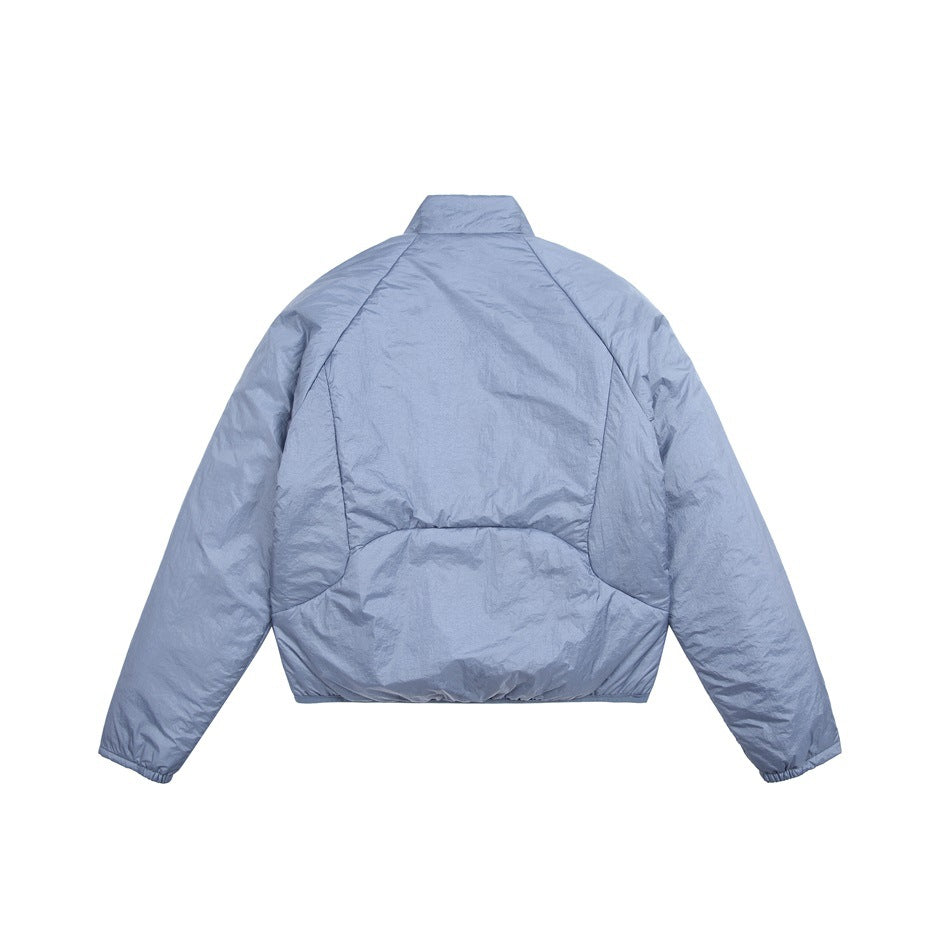 Back view of a pale blue jacket with a stand collar and curved panel seams.