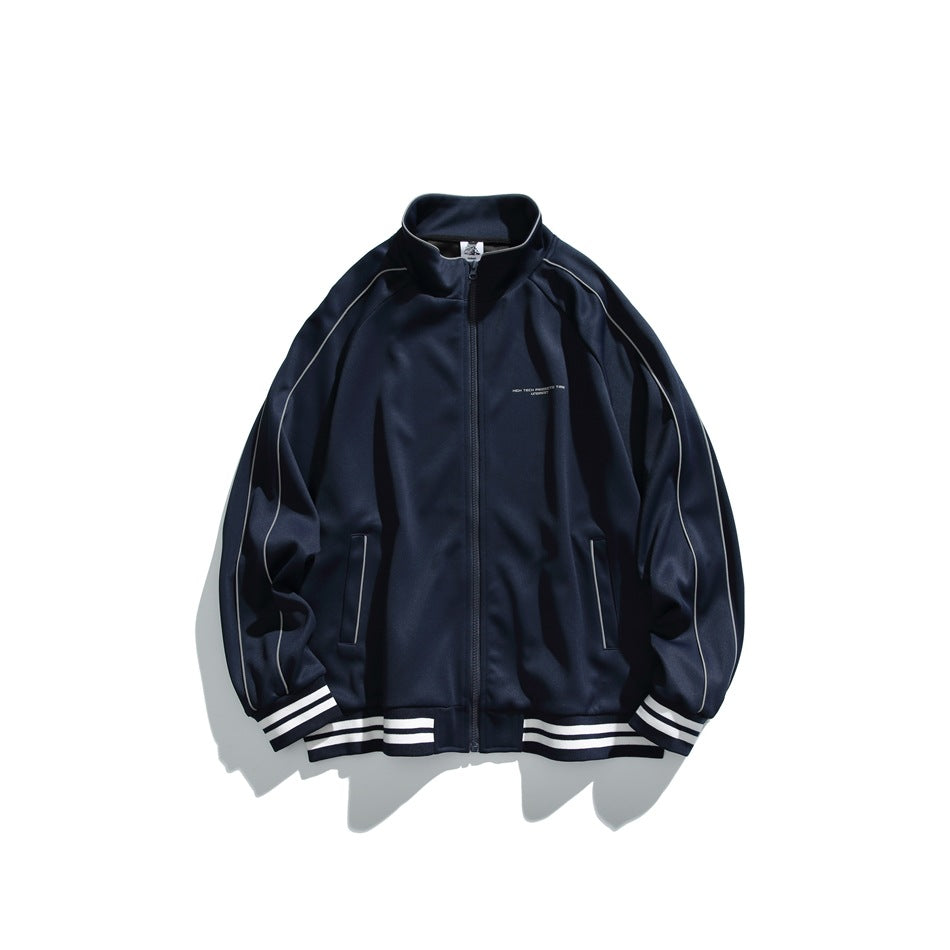 Navy zip-front stand-collar jacket with raglan sleeves, piping and white-striped ribbed cuffs and hem, flat lay