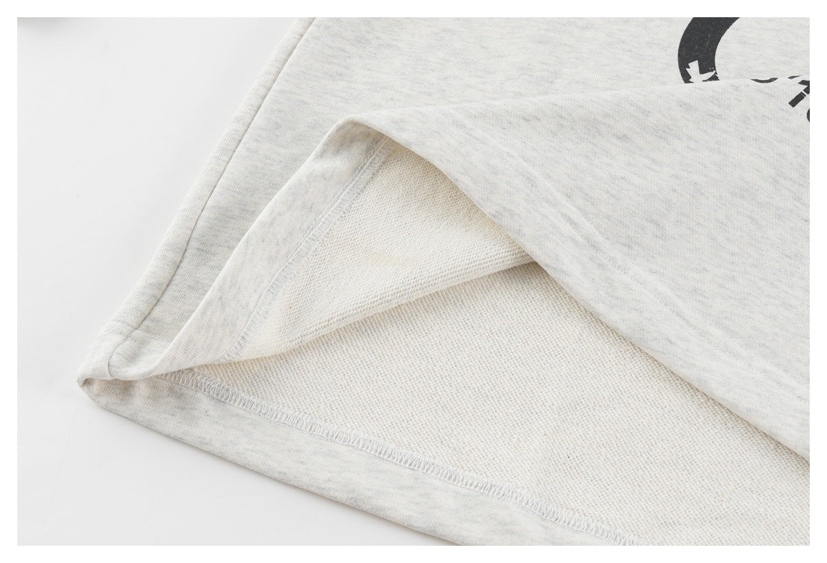 Close-up of the inside of the light gray top, showing the textured reverse fabric and seam stitching.