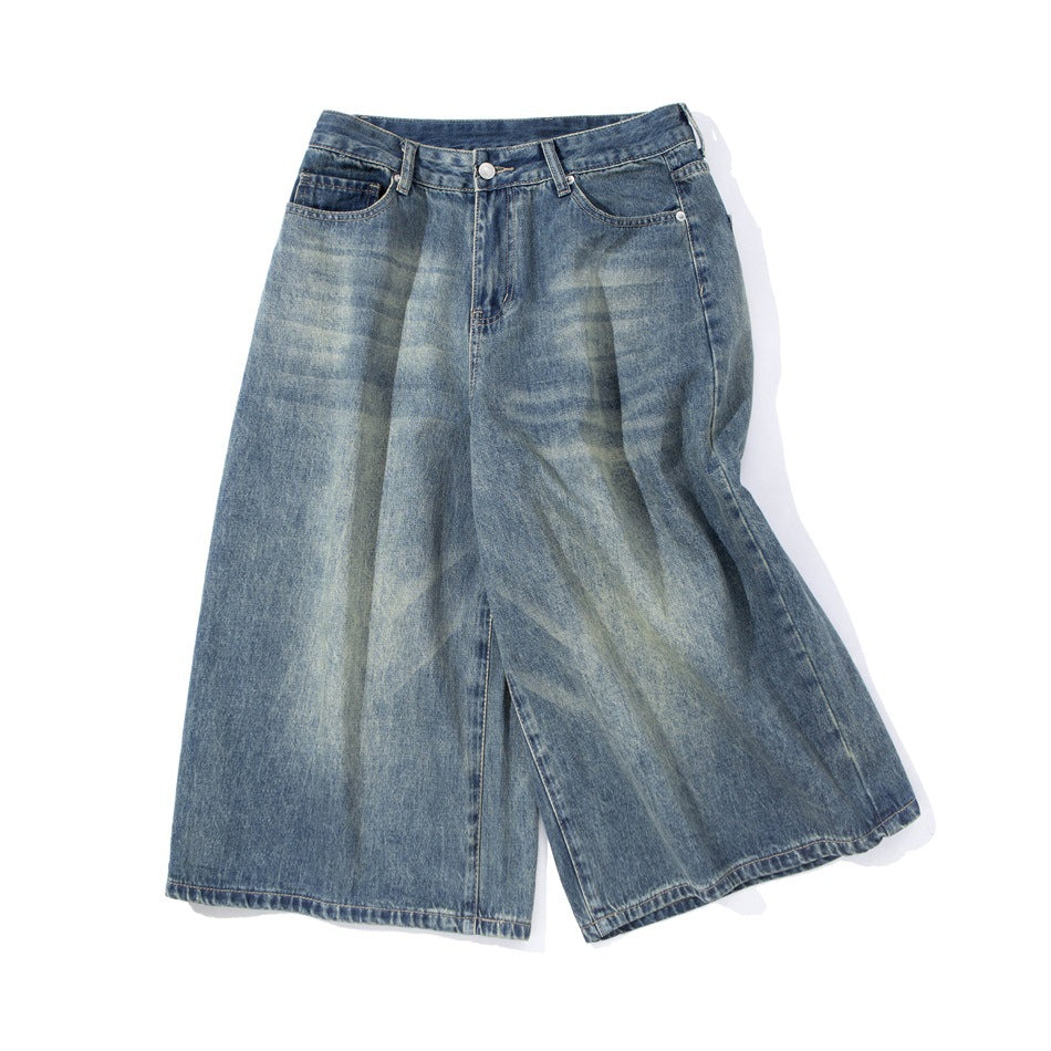 Front view of blue wide-leg denim shorts with faded wash, belt loops, button, and front pockets.