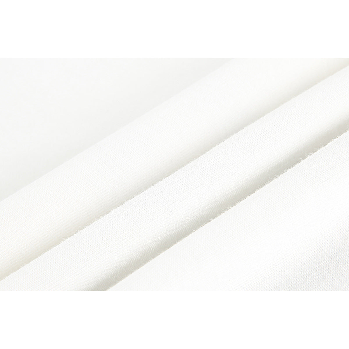 Macro view of white fabric arranged in soft folds, showing its knit texture.