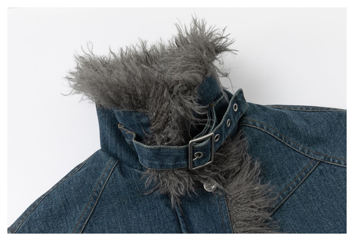 Close-up of a blue denim jacket collar with gray shaggy trim and a buckle strap.