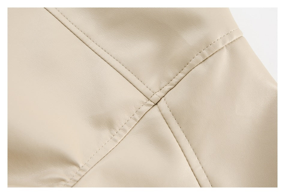 Close-up of beige garment panels meeting at a stitched seam.