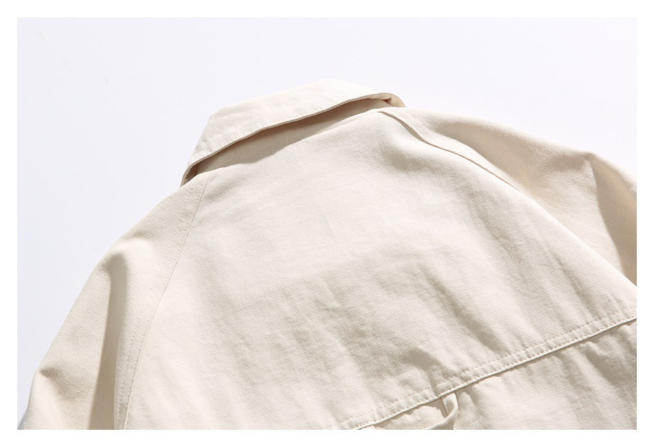 Close-up of the light beige jacket's back collar and shoulder seams.
