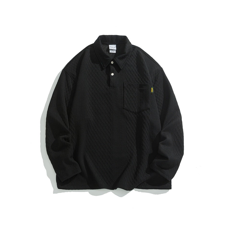Front view of a black long-sleeve collared shirt with a snap placket, chest pocket, and raised geometric texture.