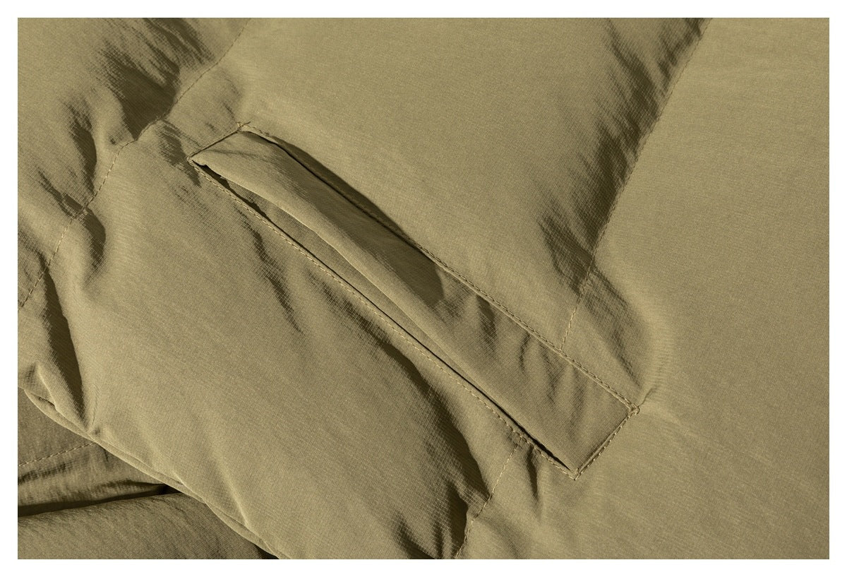 Close-up of a slanted welt pocket on an olive-tan jacket.