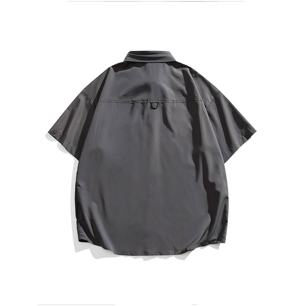 Back view of a charcoal gray short-sleeve button-up shirt with a spread collar and curved hem.