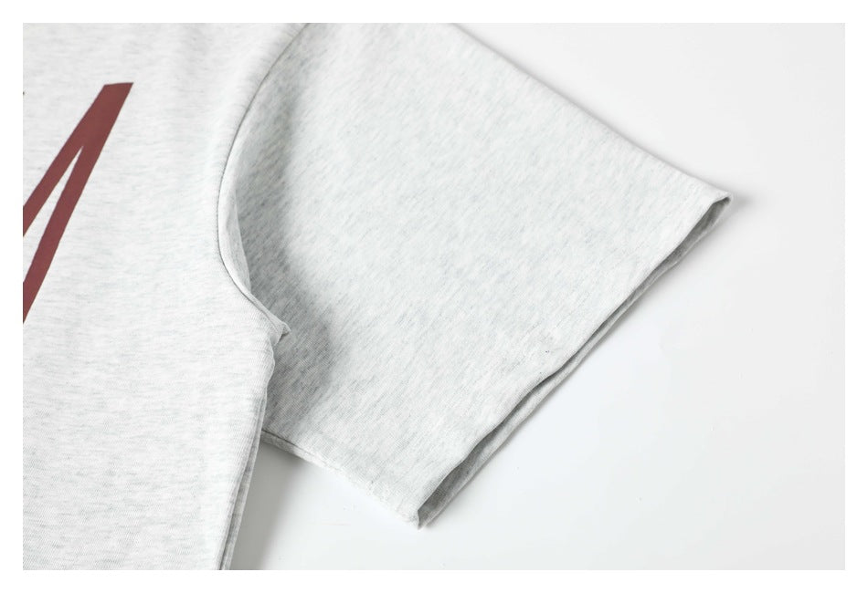 Close-up of the short sleeve and shoulder seam on a light gray heather T-shirt.