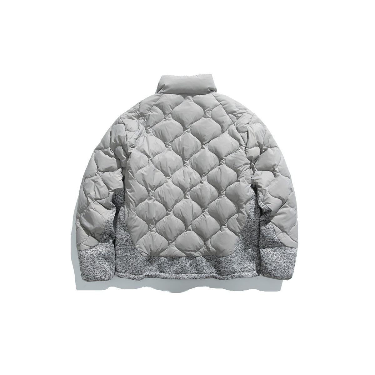 Back view of a light gray jacket with diamond quilting and mottled gray knit side and lower panels.