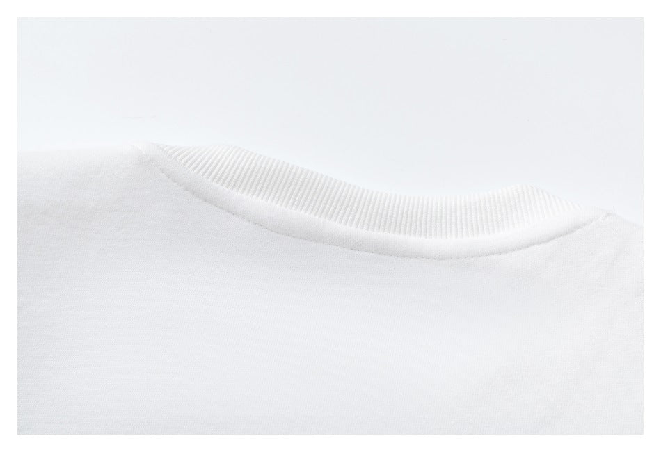 Close-up of the white garment's ribbed crew neckline.