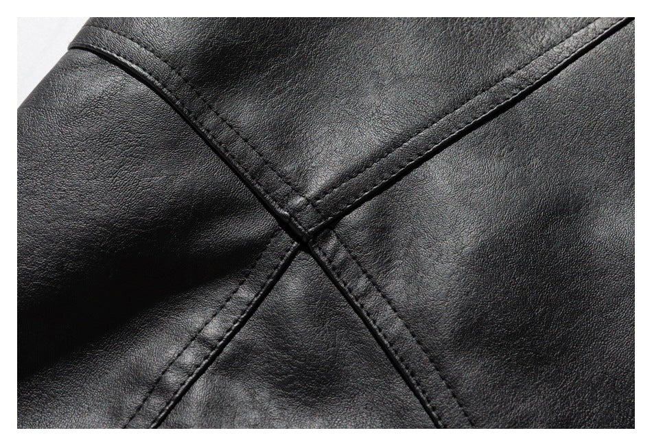 Macro view of intersecting stitched seams on black jacket material.