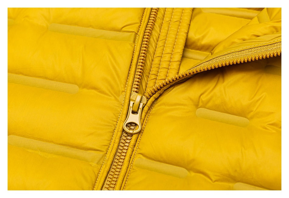 Close-up of the mustard-yellow jacket's front zipper and quilted panels.