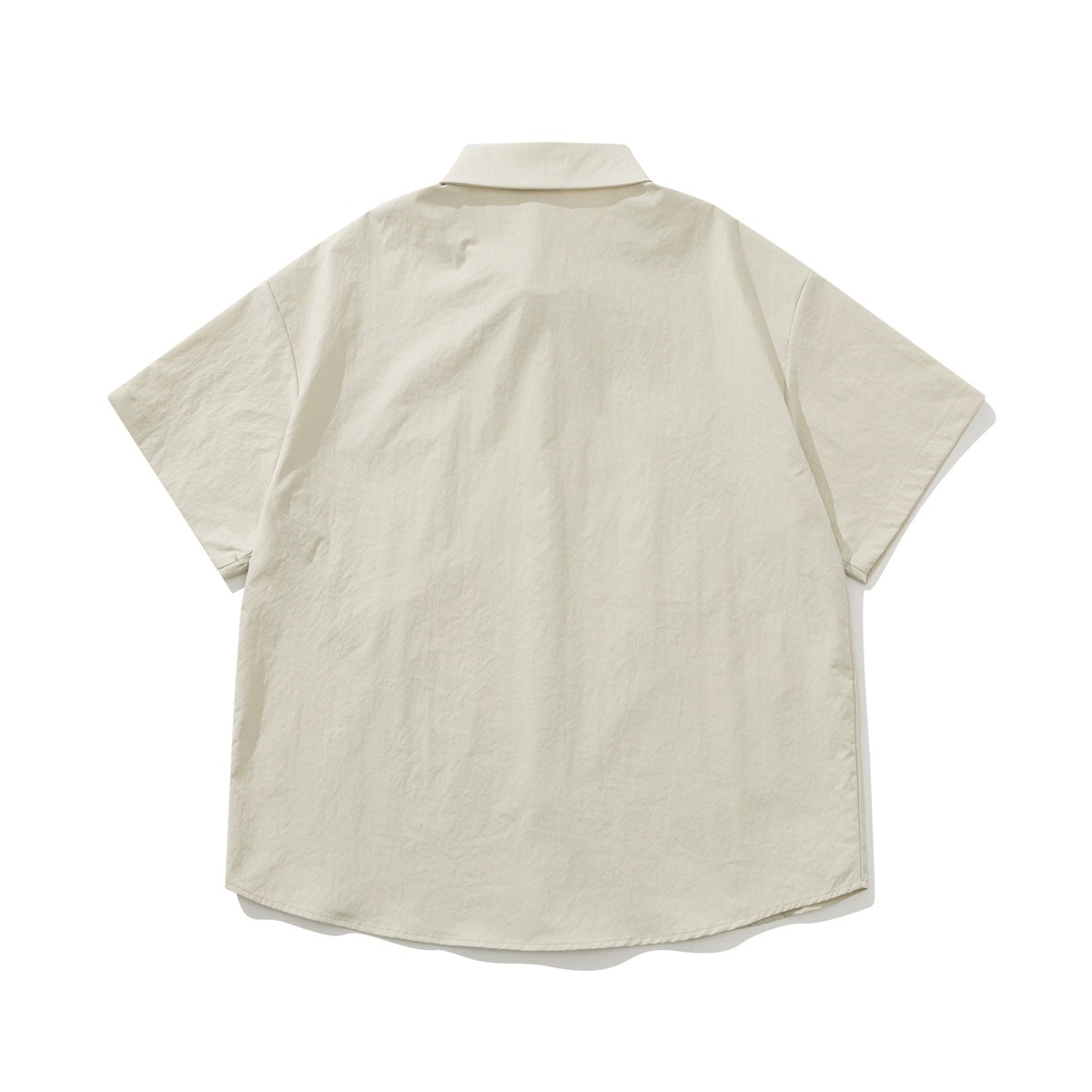 Back view of an ivory short-sleeve button-up shirt with a pointed collar and curved hem.