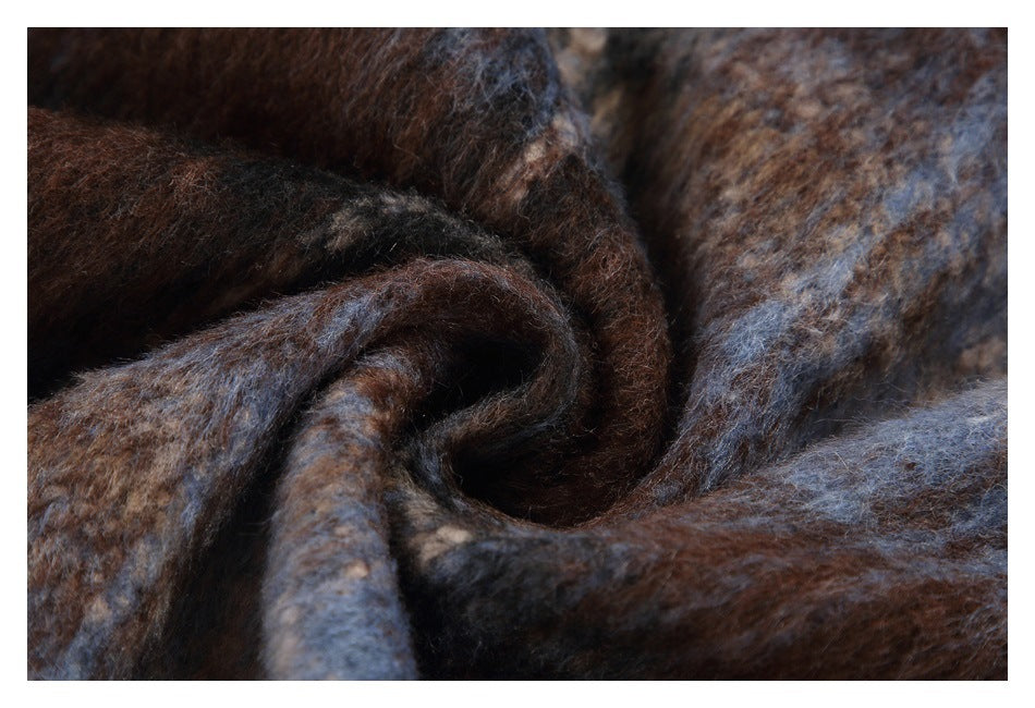 Close-up of gathered fuzzy fabric in mottled brown, slate blue, and tan.