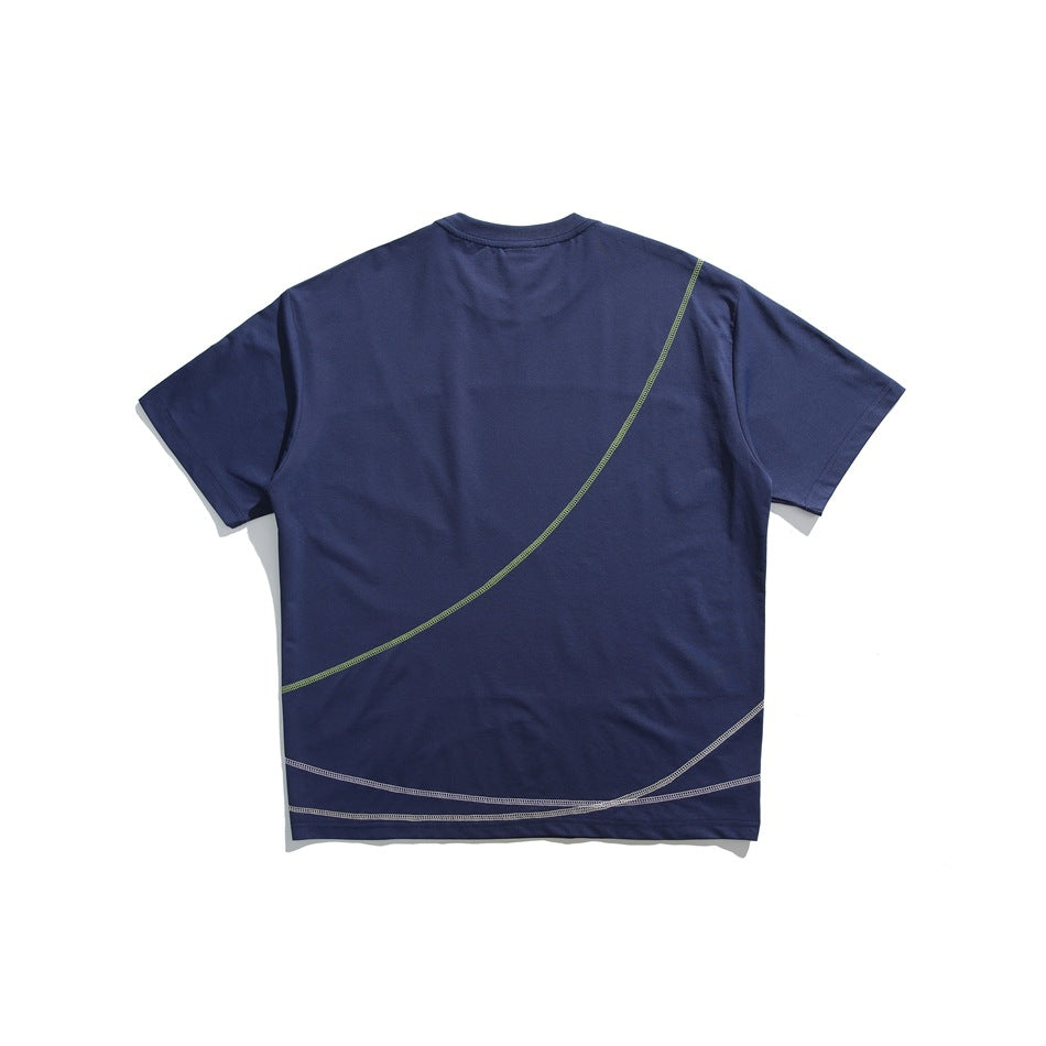 Navy short-sleeve T-shirt back view with diagonal green stitched curve and white curved stitching near the hem