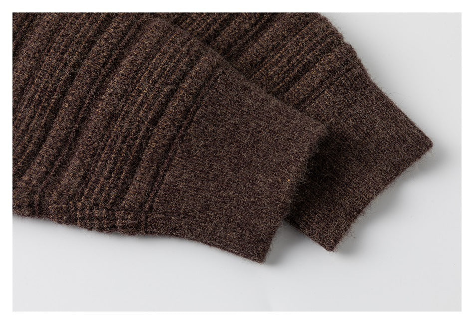 Close-up of a ribbed sleeve cuff on a dark brown textured knit garment.