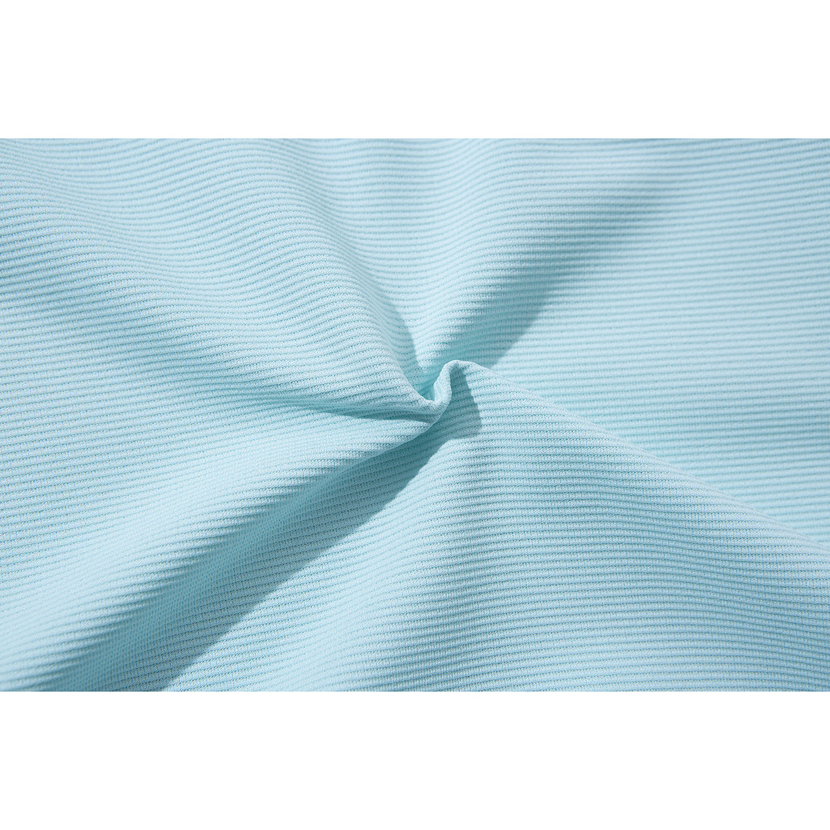 Close-up of pale blue finely textured fabric gathered into a soft fold.