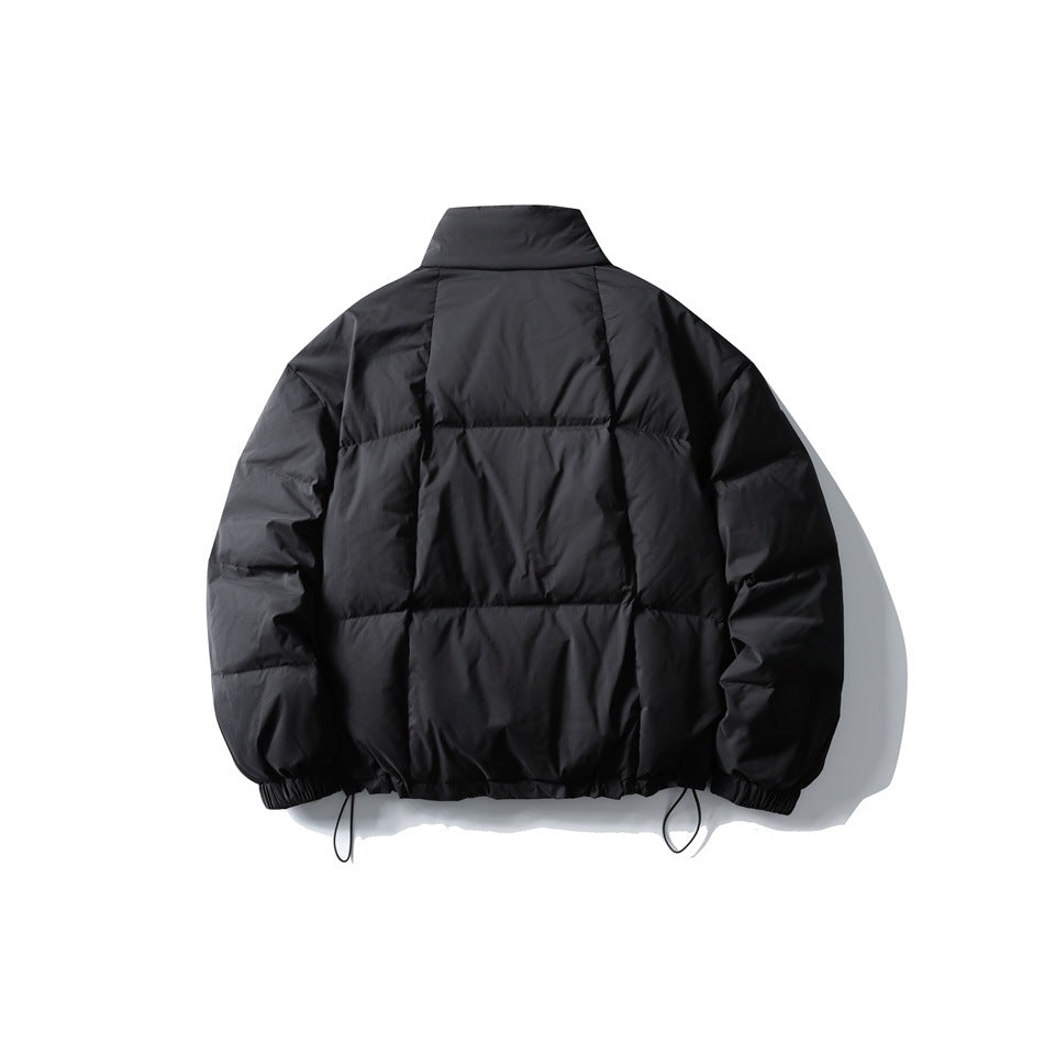 Back view of black quilted puffer jacket with stand collar, elastic cuffs and drawstring hem