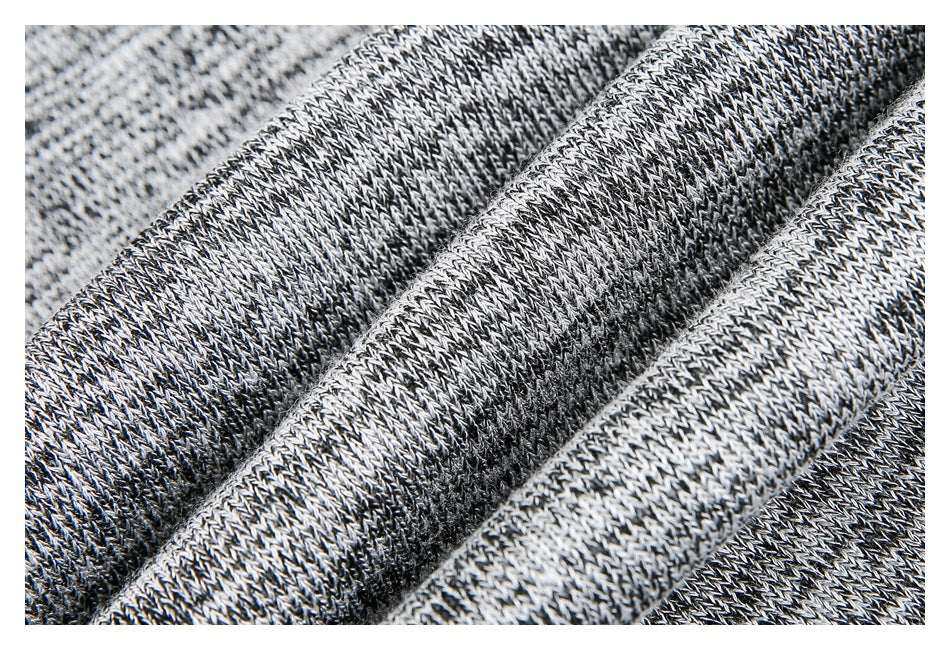 Close-up of gray and black knit fabric showing its textured stitches.