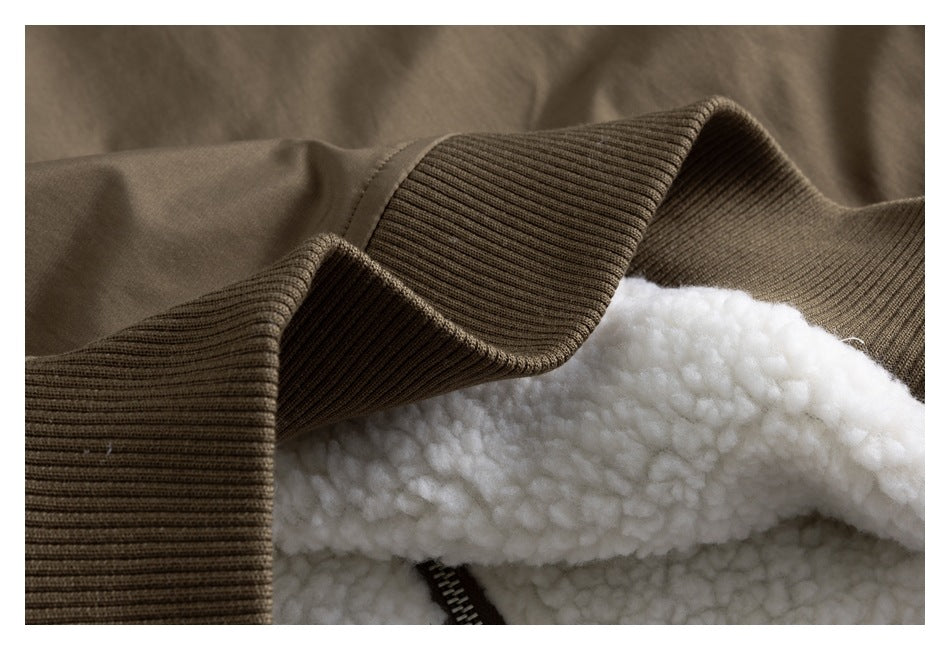 Close-up of a ribbed jacket edge, white fluffy lining, and part of a zipper.