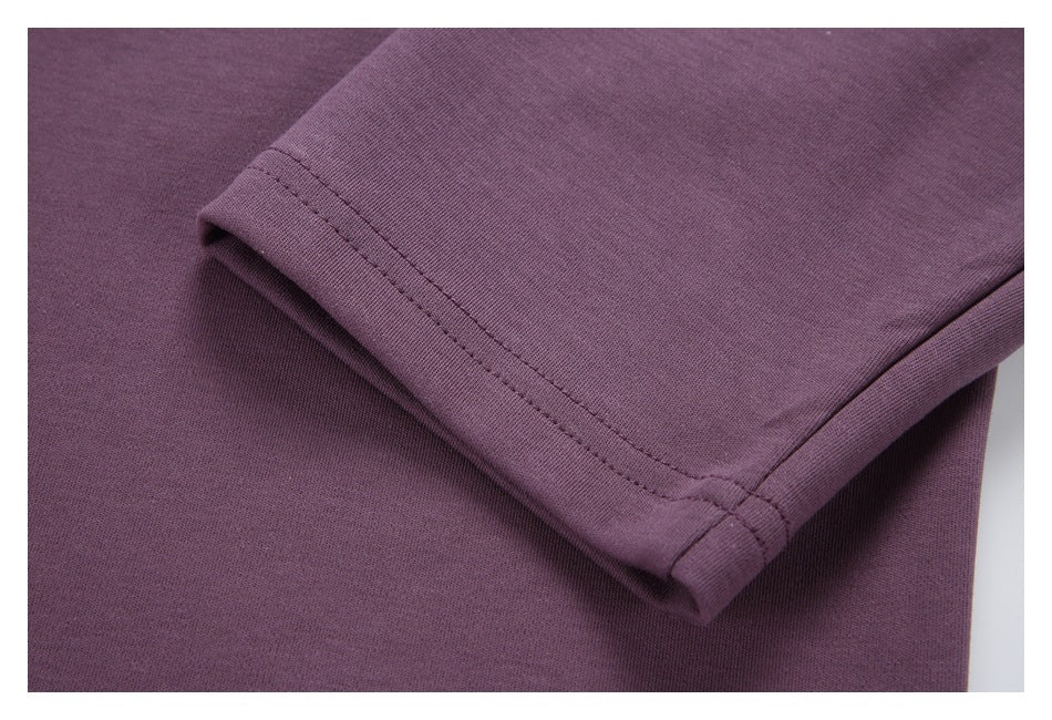 Close-up of a purple sleeve cuff with double stitching.