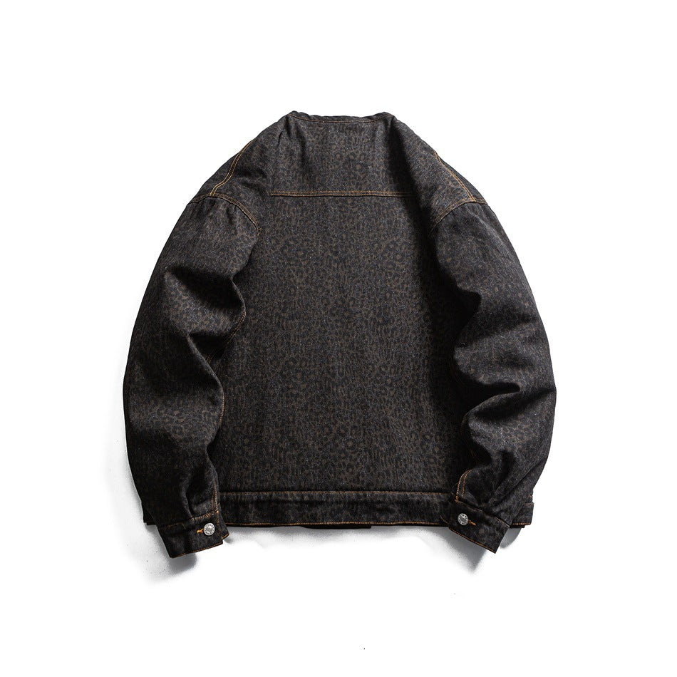 Dark charcoal denim jacket laid flat, back view, with a subtle leopard pattern and contrast stitching.