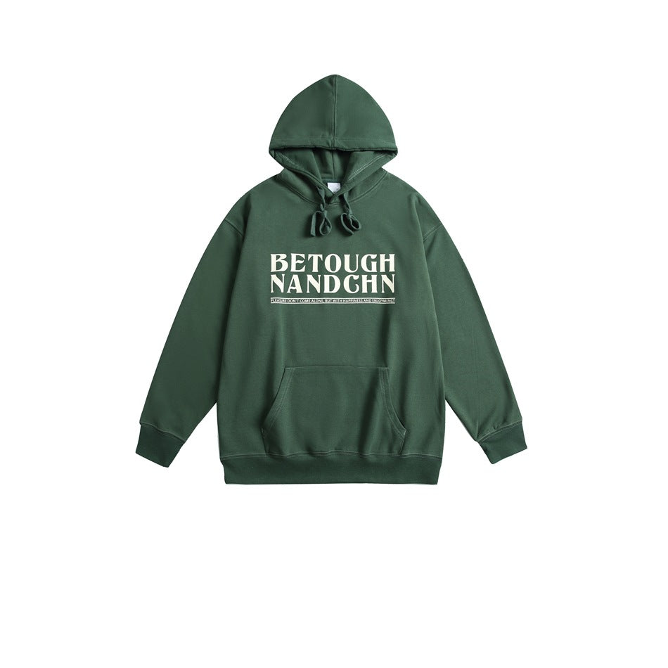 Green pullover hoodie flat lay with cream 'BETOUGH NANDCHN' chest print, front pocket and ribbed hem