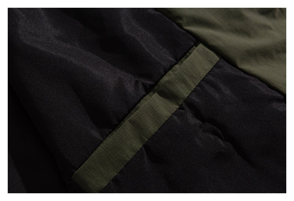 Close-up of black lining and an olive fabric seam on a garment.