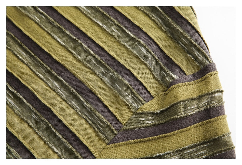 Close-up of olive, mustard, and dark brown striped fabric with textured bands and a stitched seam.