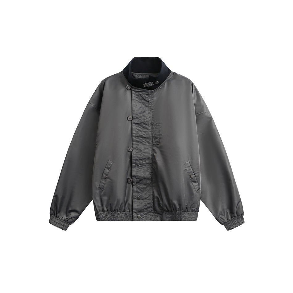 Gray stand-collar bomber jacket flat lay with an asymmetric button front, snap pockets and ribbed dark collar