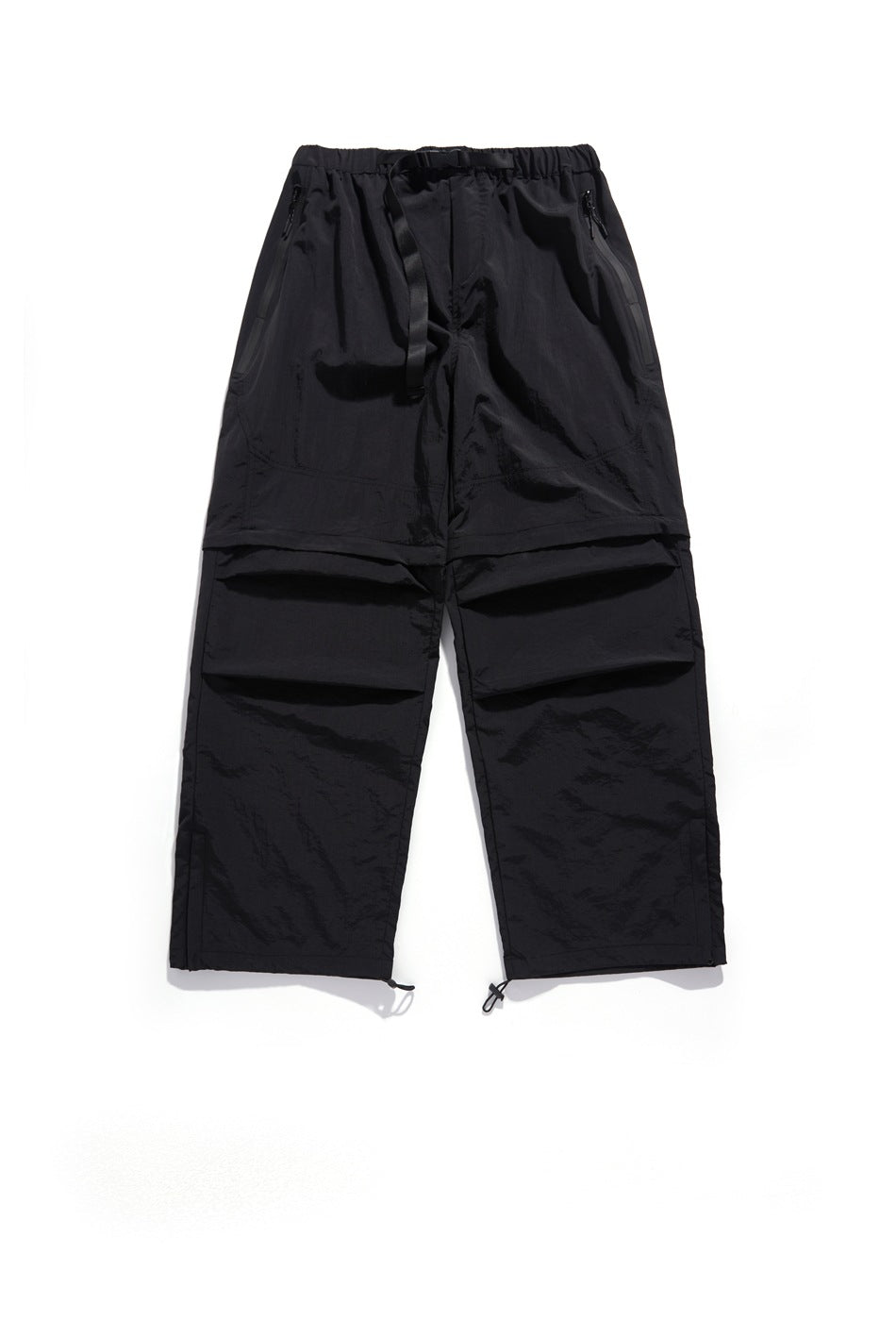 Front view of black wide-leg pants with an elastic waist, front drawcord, zip pockets, panel seams and adjustable hems.