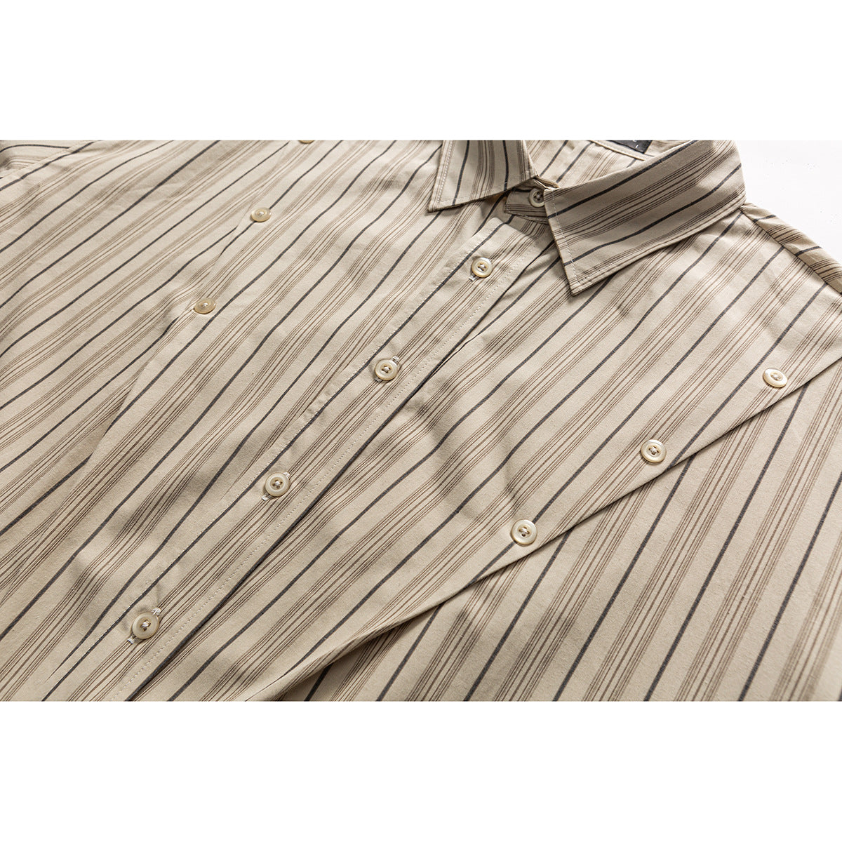 Close-up of a beige striped button-up shirt showing its collar, button placket, and buttons.