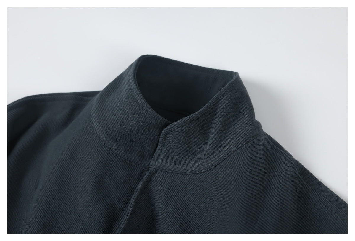 Close-up of the dark charcoal jacket's tall folded collar and upper shoulder.