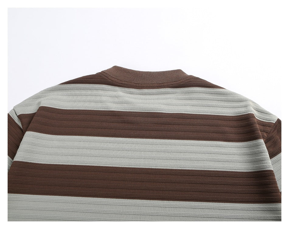 Close-up of the upper back of a brown and light gray horizontally striped crew-neck shirt.